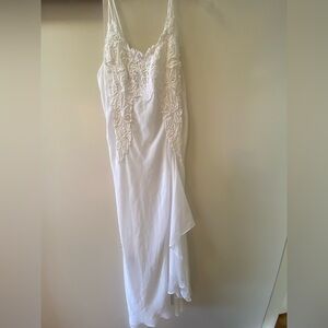 Beautiful long white nightgown with embroidery and ruffle detail.